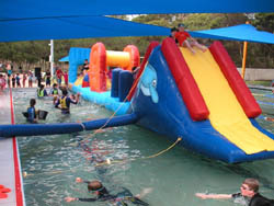 pool plaything with swimmers in clothes